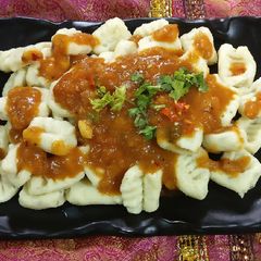 A picture of Gnocchi in tomato sauce.