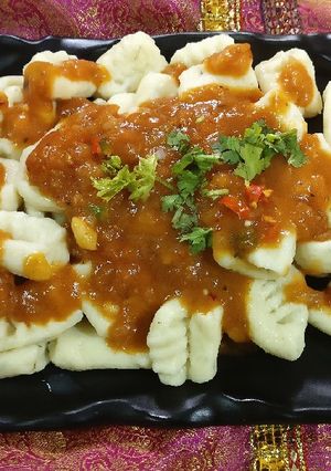 A picture of Gnocchi in tomato sauce.
