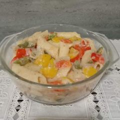 A picture of Penne pasta in white sauce.