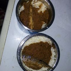 A picture of Rice and stew with fish.