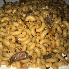 A picture of Brown macaroni with beef meat.