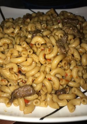 A picture of Brown macaroni with beef meat.