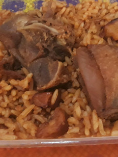 A picture of Jollof rice with chicken.