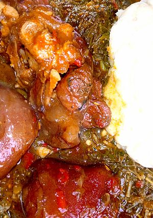 A picture of Pounded yam with groundnuts and vegetables soup.