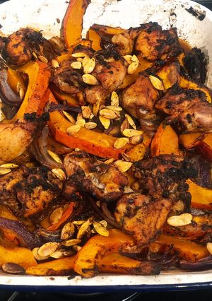 A picture of Tray bake pumpkin & chicken thighs topped with roast pumpkin seeds.