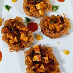 A picture of Spicy Schezwan Noodle Nest.