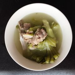 A picture of Green Mustard In Salted Fish With Pork Rib Soup.