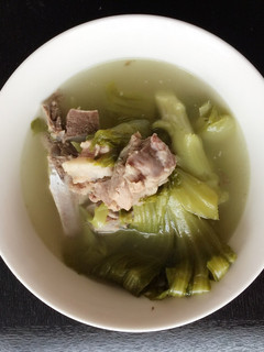 A picture of Green Mustard In Salted Fish With Pork Rib Soup.