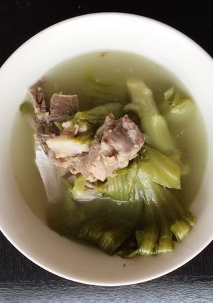A picture of Green Mustard In Salted Fish With Pork Rib Soup.