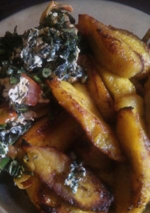 A picture of Fried plaintain with eggs and veggies.