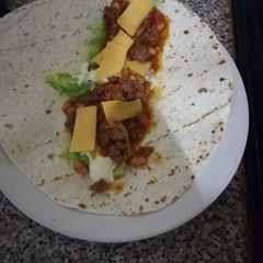A picture of Wrap with mince, lettuce and cheese.