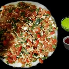 A picture of Rava Uttapam with veggies, packed with fruits and dryfruits.