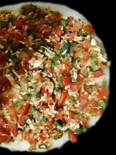 A picture of Rava Uttapam with veggies, packed with fruits and dryfruits.