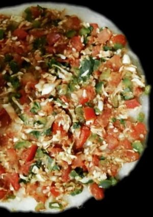 A picture of Rava Uttapam with veggies, packed with fruits and dryfruits.