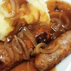 A picture of Bangers, mash n onion gravy.