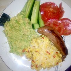 A picture of Scrambled eggs with tomato and mozzarella topping.