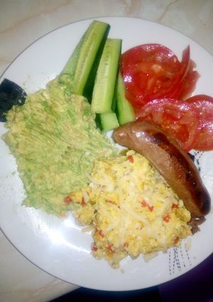 A picture of Scrambled eggs with tomato and mozzarella topping.