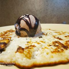 A picture of Banana Pan Cake with Chocolate Ice cream.