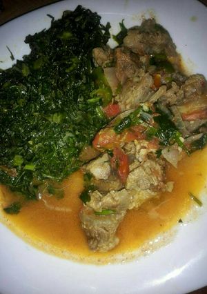 A picture of Beef stew and Fried Kale.