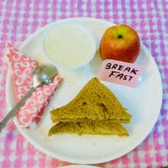A picture of #Wheat bread-peanut butter toast,dry fruits porridge and an Apple.