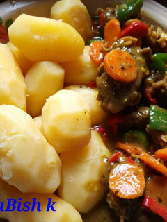 A picture of Boiled irish potatoes with minced meat sauce.