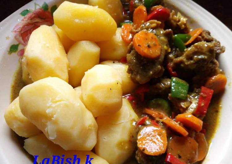 Boiled irish potatoes with minced meat sauce