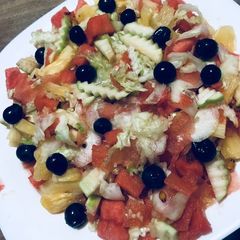 A picture of Cucumber watermelon grape lettuce pineapple salad.