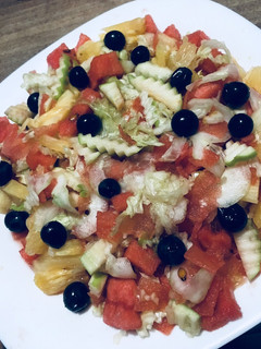 A picture of Cucumber watermelon grape lettuce pineapple salad.
