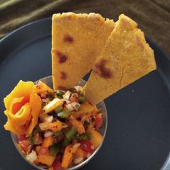 A picture of Mango Salsa with Corn Sticks.