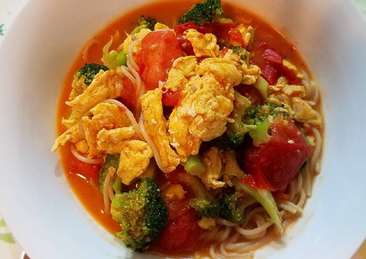 Scrambled eggs, broccoli and tomatoes over pasta Scrambled eggs, broccoli and tomatoes over pasta