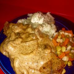 A picture of Cajun lemon pepper grilled strip steak w/ grilled onion 🍄 cream sauce and loaded 🥔 & seasoned veggie.