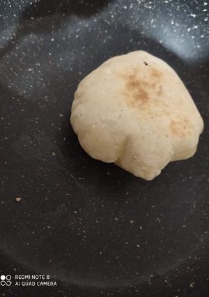 A picture of Baladi Bread on the Stovetop.