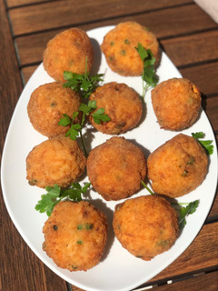 Una foto de Arancini croquetas con sabor a Sicilia y se caracterizan por un color anaranjado