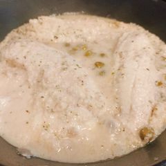 A picture of Tilapia in the frying pan.
