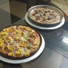 A picture of Cheeseburst Paneer Pizza & Paneer Tikka Pizza.