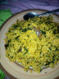 A picture of Local jollof rice garnished with vegetable.