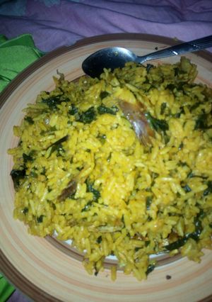 A picture of Local jollof rice garnished with vegetable.
