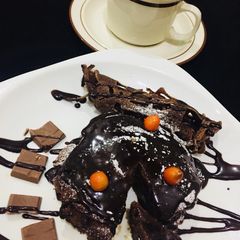 A picture of Black coffee with chocolate pancakes.