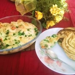 A picture of Baked veggies in white sauce.