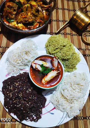 A picture of Colourful Stringhoppers with Crab stew.