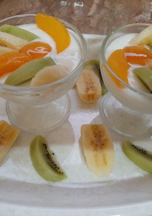 A picture of Curd with fruits and honey.