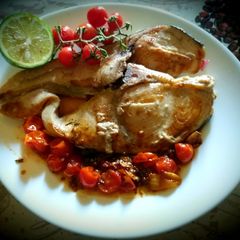 A picture of Slice of grilled swordfish in cherry tomato sauce😋😋👍😛.