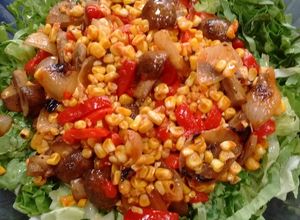 Una foto de Ensalada de vegetales cocidos sobre colchón de hojas verdes