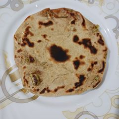 A picture of Sattu and green onion paratha.