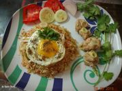 A picture of fried fish and cabbage rice