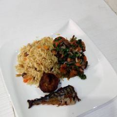 A picture of Spinach sauce with shrimps and coconut rice.