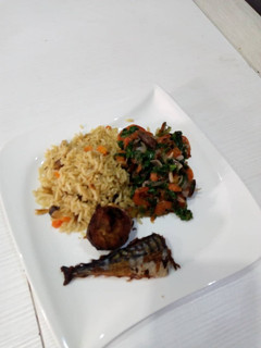 A picture of Spinach sauce with shrimps and coconut rice.