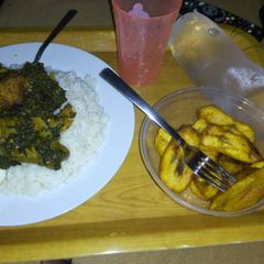 A picture of Rice, vegetable, meat, egg and plantain.