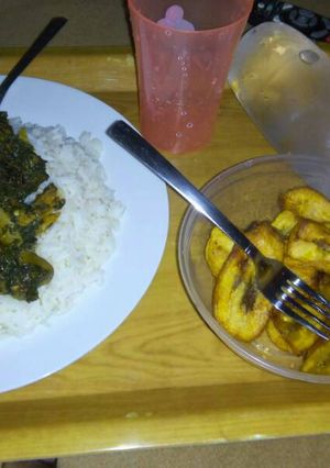 A picture of Rice, vegetable, meat, egg and plantain.