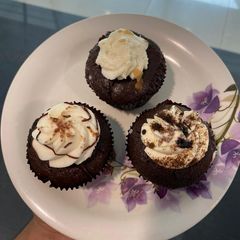 A picture of Chocolate Cup cakes with whipped cream frosting.